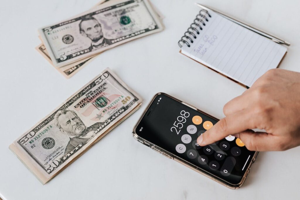 Calculating a Brighter Financial Future - Illustration of a calculator alongside currency, symbolizing the financial calculations and expert tips discussed in the blog for improving your financial well-being.