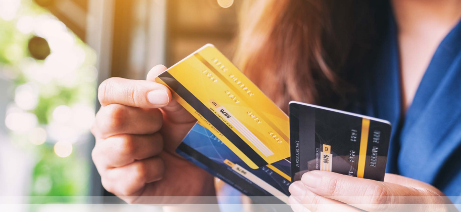 Hand holding lots of credit cards, illustrating the good and bad of easy credit. Emphasizing the need to know about finances for smarter long-term choices, especially for your credit score.