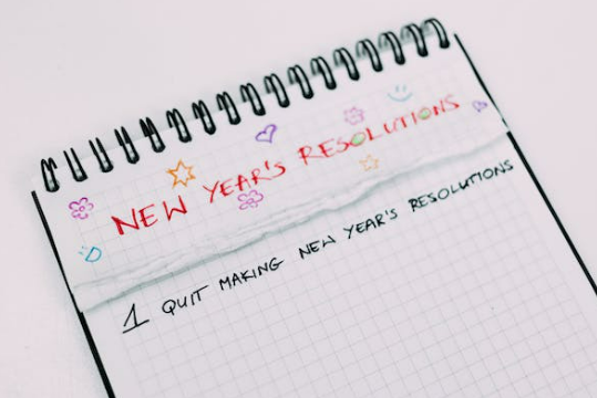 Image featuring a paper titled '2024 New Year's Resolutions.' Dive into practical insights on achieving and maintaining your New Year's resolutions, setting the tone for a successful year ahead.