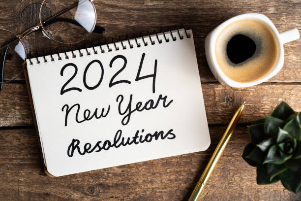 Image of a paper with handwritten text '2024 New Year's Resolutions.' Explore realistic strategies to achieve and sustain your New Year's resolutions in the upcoming year.