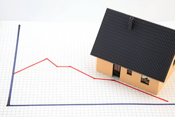 A house positioned on a downward-trending graph, illustrating the impact of the cash rate on home buying decisions and the risks of waiting for lower rates.